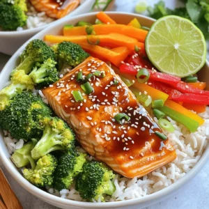 - 2 fresh salmon fillets (approximately 6 oz each) - 1 cup cooked jasmine rice - 1 cup broccoli florets - 1 red bell pepper, thinly sliced - 1 medium carrot, julienned - 2 tablespoons soy sauce - 2 tablespoons honey - 1 tablespoon rice vinegar - 1 tablespoon sesame oil - 1 teaspoon freshly grated ginger - 1 teaspoon minced garlic - 1 tablespoon sesame seeds, toasted - Optional: sliced green onions for garnish Using fresh ingredients makes a big difference in taste. Fresh salmon has a rich flavor and a tender texture. Fresh veggies add crunch and color to your dish. They also provide better nutrition. When making teriyaki salmon bowls, always choose high-quality, seasonal ingredients. This choice ensures your meal is not only tasty but also wholesome. Salmon is a superfood packed with nutrients. It is high in omega-3 fatty acids, which are great for heart health. Omega-3s help reduce inflammation and improve brain function. Salmon also provides a good source of protein, which helps build muscles and keep you full. Plus, it is rich in vitamins like B12 and D. Eating salmon regularly can support overall health, making it a smart choice for your teriyaki salmon bowls. To start, you need to make the teriyaki sauce. In a small bowl, mix: - 2 tablespoons soy sauce - 2 tablespoons honey - 1 tablespoon rice vinegar - 1 tablespoon sesame oil - 1 teaspoon freshly grated ginger - 1 teaspoon minced garlic Whisk these ingredients together until smooth. This sauce is key for flavor. Set it aside for later. Next, preheat your oven to 400°F (200°C). Line a baking sheet with parchment paper to keep it clean. Place the salmon fillets skin-side down on the sheet. Brush half of the teriyaki sauce over the fillets. Make sure they are coated well. Now, it's time to add the veggies. Place broccoli florets, sliced red bell pepper, and julienned carrot around the salmon. Drizzle the rest of the teriyaki sauce over the vegetables. This adds great taste as they cook together. Put the baking sheet in the oven. Bake for 12-15 minutes. The salmon is ready when it flakes easily with a fork. The veggies should be tender but still bright and crisp. When everything is cooked, grab your serving bowls. Start with a scoop of jasmine rice in each bowl. Top the rice with the glazed salmon and the roasted vegetables. Arrange them nicely for a lovely look. To finish, sprinkle toasted sesame seeds on top. Add sliced green onions for color and freshness. This adds a nice touch to your meal. Enjoy your tasty teriyaki salmon bowls! For the full recipe, check out the link provided. To make a great teriyaki sauce, balance is key. You want a mix of sweet and salty. Use fresh ingredients like ginger and garlic for a bright flavor. If you like more heat, add a pinch of chili flakes. Let the salmon soak in the sauce for at least 30 minutes to absorb all the flavors. This will elevate your dish. Cooking salmon can be tricky. To get the best texture, select thick fillets. They cook evenly and stay moist. Bake at 400°F (200°C) for 12-15 minutes. This time allows the salmon to flake easily. If you want a crispy skin, broil it for the last few minutes. Keep an eye on it to avoid burning. A beautiful dish is more appetizing. Arrange the salmon and vegetables in a colorful way. Use a variety of colors like green broccoli and bright red bell pepper. Add a sprinkle of toasted sesame seeds for crunch. A slice of lime on the side adds a fresh touch. For a classy look, use bowls that contrast with your food. This makes each bite more inviting. {{image_4}} You can easily swap salmon for other proteins. Try using chicken or tofu. Chicken thighs work well, too, offering a juicy bite. Tofu absorbs flavors nicely, making it a great option for vegetarians. Cook chicken in the same teriyaki sauce for a tasty alternative. For tofu, use firm or extra-firm. Press it to remove extra water, then marinate it in the sauce before cooking. This way, every bite is flavorful. Feel free to switch up the veggies in your bowl. Snap peas, carrots, or bok choy are great choices. You can also add zucchini or mushrooms. These veggies add color and crunch. Just cut them into bite-sized pieces. Roasting them with the salmon will keep them crisp and delicious. Don't be afraid to mix and match; it’s all about what you enjoy. While jasmine rice is a classic choice, other grains work, too. Quinoa adds a nutty flavor and is high in protein. Brown rice offers a chewy texture and more fiber. For a lighter option, use cauliflower rice. It’s low in carbs and absorbs flavors well. Just cook it for a shorter time to keep it tender. Each alternative brings its own twist to your teriyaki salmon bowl, making it fun and fresh. For the full recipe, check out the detailed steps above. Store your teriyaki salmon bowls in an airtight container. Make sure to cool them down first. Keep them in the fridge for up to three days. This will keep the salmon and veggies fresh. To reheat, use a microwave or oven. If using a microwave, cover the bowl with a damp paper towel. Heat for about 1-2 minutes until warm. If using the oven, set it to 350°F (175°C). Place the bowl in for about 10 minutes. This helps keep the salmon moist. You can freeze the salmon and vegetables. Place them in a freezer-safe container. They will last for up to three months. However, cooked rice does not freeze well. For the best taste, eat it fresh. When you're ready, thaw the salmon in the fridge overnight before reheating. If you follow these tips, your teriyaki salmon bowls will taste great later! For the full recipe, check out the details above. The best way to cook salmon is to bake it. Baking gives you tender, juicy fish. Preheat your oven to 400°F (200°C). Place your salmon fillet on a lined baking sheet. Brush it with teriyaki sauce for added flavor. Bake for about 12-15 minutes. The fish is done when it flakes easily with a fork. Yes, you can use other sauces. If you want a different flavor, try miso or honey mustard. You can also use spicy sauces if you like heat. Just make sure the sauce complements the salmon. Always taste your sauce before using it. To make teriyaki salmon bowls gluten-free, use gluten-free soy sauce or tamari. These options taste similar but do not contain wheat. Check all other ingredients too. Some brands of rice vinegar may add gluten. Always read labels. Good side dishes include steamed vegetables or a simple salad. You can also serve it with edamame or pickled cucumbers. If you want more carbs, try quinoa or brown rice. Each side dish complements the flavors of the salmon. This blog post covered essential ingredients and their importance for tasty teriyaki salmon bowls. Fresh ingredients boost flavor and offer health benefits. I shared step-by-step instructions to make it easy for you. You can enhance your dish with tips and variations, ensuring everyone can enjoy it. Lastly, I provided storage info to keep leftovers fresh. Enjoy making and sharing this delicious meal with family and friends. You’ll love the process and the taste!