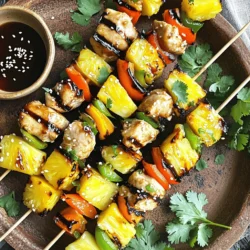 - 1 lb boneless chicken breast, cut into 1-inch cubes - 1 cup fresh pineapple, cut into 1-inch chunks - 1 bell pepper, either red or yellow, cut into 1-inch squares - 1 medium red onion, cut into wedges - 1/4 cup soy sauce - 1/4 cup teriyaki sauce - 2 tablespoons honey - 1 tablespoon sesame oil - 2 cloves garlic, minced - 1 teaspoon fresh ginger, finely grated - Salt and pepper, to taste - Skewers (if wooden, soaked in water for at least 30 minutes) - Alternative vegetables: zucchini, cherry tomatoes - Spices for added flavor: crushed red pepper, black pepper Using fresh and vibrant ingredients is key to great taste. The chicken provides a nice protein base. Pineapple adds a sweet and tangy flavor. Bell peppers bring color and crunch. Red onion gives a bit of bite. The marinade is where the magic happens. Soy sauce and teriyaki sauce blend for umami. Honey adds sweetness and helps caramelize on the grill. Sesame oil gives a nutty depth. Garlic and ginger add a fresh and zesty kick. Feel free to mix in other veggies. Zucchini and cherry tomatoes are tasty options. They cook quickly and add more flavor. For spice lovers, crushed red pepper or black pepper provides a nice heat. For the full recipe, check the details above to get started on your skewers. To start, you need to make the marinade. In a bowl, mix these ingredients: - 1/4 cup soy sauce - 1/4 cup teriyaki sauce - 2 tablespoons honey - 1 tablespoon sesame oil - 2 cloves garlic, minced - 1 teaspoon fresh ginger, finely grated - Salt and pepper, to taste Add 1 pound of boneless chicken breast, cut into 1-inch cubes. Make sure every piece is covered. Cover the bowl with plastic wrap. Put it in the fridge. Let the chicken marinate for at least 30 minutes. For the best flavor, let it sit for up to 2 hours. While the chicken marinates, get your skewers ready. If they are wooden, soak them in water for at least 30 minutes. This helps prevent burning. Next, preheat your grill or grill pan to medium-high heat. After marinating, take the chicken out of the fridge. Carefully thread the marinated chicken, fresh pineapple chunks, bell pepper squares, and red onion wedges onto the skewers. Alternate the ingredients for a colorful look. Now, place the skewers on the hot grill. Grill them for about 10-12 minutes. Turn them every few minutes to cook evenly and get nice grill marks. Use a meat thermometer to check that the chicken reaches 165°F (75°C). This means it is fully cooked. For an extra flavor boost, brush the skewers with any leftover marinade in the last 2-3 minutes of grilling. Once done, take them off the grill and let them rest for a few minutes. This helps keep the juices inside. Serve the skewers warm and enjoy! For the full recipe, refer to the earlier sections. For the best flavor, marinate your chicken for at least 30 minutes. However, if you have more time, let it soak for up to 2 hours. This helps the chicken absorb all those tasty flavors! If you're looking for a gluten-free option, you can swap soy sauce with coconut aminos or tamari. Both keep the savory taste without gluten. Keep your grill at a steady medium-high heat. This helps cook the chicken evenly and gives nice grill marks. To achieve those perfect grill marks, place the skewers at a diagonal on the grill. After a few minutes, rotate them a quarter turn. This simple move creates an eye-catching pattern and enhances flavor. When serving, place your skewers on a big platter. Garnish with fresh cilantro or sprinkle sesame seeds on top. It adds color and makes the dish pop! Pair these skewers with jasmine rice or a fresh salad for a balanced meal. A small bowl of teriyaki sauce for dipping can elevate your dish even more. For the full recipe, check out the detailed steps above. {{image_4}} You can easily switch out the chicken for shrimp or tofu. Shrimp cooks quickly and adds a nice twist. Tofu works well for a plant-based option. For flavor, try different marinades. A spicy chili sauce or a sweet mango glaze can change the taste completely. Using seasonal vegetables can make your skewers even better. Think about adding zucchini, cherry tomatoes, or bell peppers. They add color and taste. Fresh herbs like cilantro or basil also make great garnishes. They give a lovely pop of flavor and look nice on the plate. If you want vegetarian or vegan options, swap chicken for hearty vegetables or tempeh. This keeps the dish filling. For those watching their sodium, use low-sodium soy sauce and teriyaki sauce. You can still enjoy great taste without the extra salt. For the full recipe, please check out [Full Recipe]. To keep your Pineapple Teriyaki Chicken Skewers fresh, use proper refrigeration. First, let the skewers cool to room temperature. Then, place them in an airtight container. This helps keep moisture in and flavors intact. You can also wrap them tightly in plastic wrap. Store the skewers in the fridge for up to three days. Reheating is simple and should keep your skewers juicy. The best way is to use an oven. Preheat your oven to 350°F (175°C). Place the skewers on a baking sheet. Cover them with aluminum foil to trap moisture. Heat for about 10-15 minutes. You can also use a microwave, but they can dry out. Heat in short bursts and cover with a damp paper towel. If you want to save skewers for later, you can freeze them. First, let the cooked skewers cool down. Then, wrap them tightly in plastic wrap and foil. This prevents freezer burn. You can store them for up to three months. When you’re ready to eat, thaw them overnight in the fridge. Reheat them using the methods above for the best taste. You can tell when chicken skewers are done by checking their color and texture. The chicken should be opaque and firm to the touch. The juices should run clear, not pink. The best way to be sure is to use a meat thermometer. It should read 165°F (75°C) for safe eating. This ensures that harmful bacteria are gone. Yes, you can make Pineapple Teriyaki Chicken Skewers ahead of time. Marinating the chicken is key. You can marinate it for up to 2 hours. If you want to prepare earlier, marinate the chicken and store it in the fridge. You can also cut the veggies and pineapple ahead. Just keep them in the fridge too. This way, you save time when you're ready to grill! You can serve these skewers with many tasty sides. Rice or quinoa works great as a base. You can also pair them with grilled veggies or a fresh salad. For drinks, try serving iced tea or a light lemonade. These choices balance the sweet and savory flavors of the skewers. Enjoy your meal with friends and family! This blog post covered how to make Pineapple Teriyaki Chicken Skewers. We explored main ingredients and marinades, step-by-step grilling, and serving tips. I shared variations to suit your taste and dietary needs. Finally, I offered storage and reheating advice for leftovers. Try these skewers for a fun meal. Experiment with different flavors and ingredients. Enjoy the bright taste and simple process! You’ll impress your family and friends with this dish.