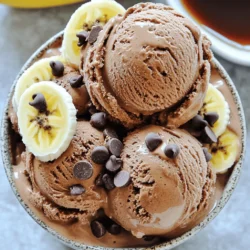 - 4 ripe bananas, sliced and frozen - 1/4 cup unsweetened cocoa powder - 1/4 cup almond milk (or any plant-based milk of your choice) - 1 tablespoon maple syrup (optional, for an extra touch of sweetness) - 1 teaspoon pure vanilla extract - A pinch of sea salt - Vegan chocolate chips or chunks (for topping, optional) To make Vegan Banana Chocolate Ice Cream, gather these simple ingredients. Start with ripe bananas. They must be sweet and soft. Slice them and freeze them ahead of time. This step is key for a creamy texture. Next, you need unsweetened cocoa powder. This gives your ice cream a rich chocolate flavor. Use high-quality cocoa for the best taste. You also need a plant-based milk. Almond milk works well, but feel free to use any milk you like. The milk helps blend everything smoothly. If you want, add maple syrup for extra sweetness. It complements the banana flavor nicely. Just a tablespoon should do, but adjust to your taste. Pure vanilla extract adds depth to the flavor. A little goes a long way. Lastly, don’t forget a pinch of sea salt. It balances all the flavors. If you love chocolate, consider adding vegan chocolate chips on top. They make a nice treat when serving. These ingredients come together to create a simple and creamy dessert. Enjoy making this vegan ice cream that is both delicious and easy! - Start with ripe bananas. These will give you the best flavor. - Slice the bananas into thin rounds. This makes them easier to freeze and blend. - Spread the banana slices on a baking sheet. Make sure they don't touch. - Freeze them for at least 2 hours. This step is key for a creamy texture. - Once frozen, place the banana slices in a food processor. - Blend on high speed until smooth and creamy. This will take about 3-5 minutes. - Stop and scrape the sides of the bowl to ensure even blending. - After reaching a soft-serve texture, add unsweetened cocoa powder. - Pour in the almond milk, maple syrup, vanilla extract, and sea salt. - Blend again until everything is well mixed. Adjust almond milk for your desired creaminess. - Transfer the blended mixture into an airtight container. - Smooth the top for an even surface. Seal the container tightly. - Freeze for at least 2 hours to get the right firmness. - When ready, scoop the ice cream into bowls or cones. - Optionally, top with vegan chocolate chips for extra crunch. To get that smooth, creamy texture, adjust your almond milk. Start with a small amount. Blend your bananas first, then slowly add more almond milk if needed. This helps keep it thick and luscious. You want it to feel like soft serve. Sweetness is key too. Use maple syrup to balance the flavors. If you like it sweeter, add more syrup. Start with one tablespoon, then taste. Adjust to your liking. This will make your dessert truly shine. When serving, use pre-chilled bowls. This keeps the ice cream nice and cold. Scoop it into the bowls and make it look inviting. You can dust cocoa powder on top for a rich touch. Garnishing is fun! Add vegan chocolate chips or chunks for a tasty crunch. Slices of fresh banana on top look great and add flavor. A drizzle of maple syrup right before serving makes it even more appealing. Enjoy your beautiful creation! {{image_4}} You can change the flavor of your vegan banana chocolate ice cream easily. Adding other fruits can give it a fun twist. Try mixing in strawberries for a berry burst. You can also add peanut butter for a nutty taste. Both options work well with the chocolate flavor. Exploring different types of plant-based milk can also change the taste. Almond milk gives a light flavor. Coconut milk adds creaminess and a hint of coconut. Each milk brings a unique taste to your ice cream. Want to make your ice cream more exciting? You can add nuts or seeds. Chopped almonds or sunflower seeds add a nice crunch. They pair well with the smooth ice cream base. Swirling in nut butter is another fun idea. You can use almond butter or peanut butter. Just add it to the mixture before freezing. This creates delicious swirls and rich flavor. You can also mix in extra cocoa for a deeper chocolate taste. To keep your vegan banana chocolate ice cream creamy, store it properly. Use an airtight container. This helps prevent ice crystals from forming. Fill the container, leaving a little space at the top. This allows for expansion as it freezes. Choose a container made of glass or thick plastic. These materials help maintain temperature and texture. Avoid metal containers, as they can cause freezer burn. Your ice cream will last about 1 to 2 weeks in the freezer. After that, it may lose flavor and texture. Look for signs that the ice cream has gone bad. If you see ice crystals on top or a grainy texture, it’s time to toss it. Also, if the smell is off or the taste changes, don’t eat it. Always trust your senses to keep it safe and tasty. Yes, you can make this ice cream without a blender. Use a fork to mash the frozen bananas in a bowl. Then, mix in the cocoa powder, almond milk, and other ingredients with the fork. It will take more time and effort, but it is possible to create a tasty treat this way. If your ice cream is too hard, let it sit out for a few minutes. This will warm it slightly and make it easier to scoop. You can also microwave it for about 10 seconds. Just be careful not to melt it too much. Yes, this recipe is gluten-free. All the ingredients, like bananas, cocoa powder, and almond milk, do not contain gluten. Always check labels for any added ingredients to ensure they are gluten-free. Yes, you can use other sweeteners. Agave syrup, honey, or coconut sugar work well. Adjust the amount based on your taste. Remember, some sweeteners may add different flavors. This ice cream is rich in nutrients. Bananas provide potassium and fiber. Cocoa powder adds antioxidants. Almond milk is low in calories and dairy-free. Overall, it’s a tasty treat that can be part of a healthy diet. In this blog post, I shared how to make vegan banana chocolate ice cream. We covered the best ingredients, from ripe bananas to cocoa powder, along with step-by-step instructions. I offered tips for achieving smooth texture and tasty presentations. You can get creative with variations and learn how to store your ice cream properly. This dessert is both easy to make and delicious, making it perfect for everyone. Enjoy your homemade treat and have fun experimenting with flavors!