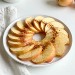 - 2 large apples (suggested varieties: Fuji or Honeycrisp) - 2 tablespoons granulated sugar - 1 teaspoon ground cinnamon - 1 tablespoon freshly squeezed lemon juice - Pinch of fine sea salt Choosing fresh apples is key for great apple chips. Look for firm apples with no bruises or soft spots. Fuji and Honeycrisp apples offer the best sweetness and crunch. If you want to switch things up, you can use coconut sugar or maple sugar instead of granulated sugar. For a different flavor, try using cinnamon sticks, which you can grind yourself. You can even mix in a bit of nutmeg for an extra kick! Using high-quality ingredients makes a big difference in taste. Freshness and flavor matter, so take your time picking your apples and spices. {{ingredient_image_2}} First, you need to preheat your oven to 200&deg;F (93&deg;C). This low heat helps the apple chips dry out well. Next, prepare a baking sheet by lining it with parchment paper. This will keep the chips from sticking and make cleanup easy. Rinse your apples under cold water and dry them with a clean towel. It&rsquo;s essential to remove any dirt. Now, core each apple to get rid of the seeds. Slice the apples thinly, about 1/8 inch thick. I recommend using a mandoline for even slices. But if you don&rsquo;t have one, a sharp knife works just fine. Drizzle the lemon juice over the apple slices. This step prevents the apples from turning brown. Toss the slices gently to coat them well. In a separate bowl, mix the granulated sugar, ground cinnamon, and a pinch of salt. Stir until everything is combined. Next, sprinkle this cinnamon sugar mix over the lemon-coated apple slices. Toss again to coat each slice well. Arrange the apple slices in a single layer on the baking sheet. Make sure they don&rsquo;t overlap. This helps them crisp up nicely. Place your baking sheet in the preheated oven and bake for about 1.5 to 2 hours. Halfway through, around 45 minutes in, flip the apple slices for even baking. Keep an eye on them as they bake. They should turn crisp and have a light golden color. Once baking is done, remove the apple chips from the oven. Let them cool completely on the baking sheet. Cooling is crucial because it helps them get extra crispy. After they cool, store the apple chips in an airtight container. This way, you can enjoy them later or share them with friends and family! To get that perfect crunch, slice the apples thinly. Aim for about 1/8 inch thick. If the slices are too thick, they will not crisp up well. A mandoline slicer is great for this, but a sharp knife works too. Baking at the right temperature is key. Keep your oven set to 200&deg;F (93&deg;C). This low heat helps the apples dry out slowly. If you want them extra crispy, you can bake them a bit longer. Just watch them closely towards the end. You can spice things up! Try adding a pinch of nutmeg for warmth. A drop of vanilla extract in the cinnamon sugar mix can add depth. For toppings, consider drizzling melted chocolate or caramel over the chips. You can also serve them with a dip like yogurt or peanut butter for a fun twist. One big mistake is overlapping the apple slices. This prevents them from getting crispy. Lay them out in a single layer on your baking sheet. Be careful with the baking time. If you under-bake, they will be chewy. If you over-bake, they can burn. Flip the slices halfway through to ensure even baking. Keep an eye on them until they reach a light golden hue. Pro Tips Choose the Right Apples: Fuji and Honeycrisp apples are ideal for their sweetness and crisp texture, which enhances the flavor of the chips. Slicing Technique: Using a mandoline slicer will ensure uniform thickness of the apple slices, leading to even baking and crispiness. Monitor Baking Time: Keep a close watch on the chips in the last 15 minutes of baking to prevent them from burning, as oven temperatures may vary. Storage Tips: Store the cooled apple chips in an airtight container at room temperature to maintain their crispness for longer. {{image_4}} You can add some fun to your apple chips! A sprinkle of cayenne gives them a spicy kick. This heat pairs well with the sweet cinnamon. If you love sweet treats, try drizzling caramel or melted chocolate on top. These options make your chips even more special and tasty. Don't feel limited to apples! You can use pears or other fruits like bananas or peaches. They work well and taste great. If you're looking for healthier options, try using sugar alternatives like stevia or monk fruit. You can also use agave syrup for a vegan twist. Want a quicker snack? Try using an air fryer! It cooks the apple slices faster while keeping them crispy. Set your air fryer to 300&deg;F (150&deg;C) and cook for about 15-20 minutes. Remember to shake the basket halfway through. You can also use the microwave for a faster option. Place apple slices on a microwave-safe plate and cook them for about 5-6 minutes. Keep an eye on them to prevent burning. This method is quick but may not get them as crispy as baking. To keep your apple chips fresh, use airtight containers. These containers keep air and moisture out. Store your chips in a cool, dry place. If stored properly, they can last about two weeks. Watch for signs of spoilage. If they feel soft or have an off smell, it&rsquo;s time to throw them away. If your apple chips soften, don&rsquo;t worry! You can bring back their crunch. Preheat your oven to 200&deg;F (93&deg;C). Place the chips on a baking sheet in a single layer. Bake them for about 10 minutes. Keep an eye on them! Once they cool, they should be crispy again. Can you freeze apple chips? Yes, you can! To freeze, let the chips cool completely after baking. Place them in a freezer-safe bag or container. Remove as much air as possible. They can stay good for about three months. When you want to eat them, thaw in the fridge or at room temperature. Enjoy the crunch whenever you like! You can use many types of apples. However, I recommend Fuji or Honeycrisp apples. They are sweet and crisp, perfect for making chips. Other good choices include Gala and Pink Lady apples. These apples hold their shape well and taste great with cinnamon sugar. Cinnamon sugar apple chips can last up to two weeks. Store them in an airtight container to keep them fresh. If you see any signs of moisture, it&rsquo;s best to toss them. To prolong their life, keep them in a cool, dry place. Yes, you can easily make a larger batch. Just double or triple the recipe as needed. Make sure to use multiple baking sheets to spread the apple slices out. This helps them bake evenly. You might need more time in the oven, so keep an eye on them. Yes, using a dehydrator is a great option! Set your dehydrator to 135&deg;F (57&deg;C). Place the apple slices on the trays, making sure they do not touch. Dehydrate for 6 to 8 hours or until crisp. This method can enhance the flavor, too! Each serving has about 100 calories. They provide fiber and vitamins from apples. The sugar adds sweetness but can be adjusted. This snack is a healthier choice than chips or candy, making it a great option for kids and adults alike. This guide takes you through making cinnamon sugar apple chips. You learned about choosing the right apples and key ingredients. I shared details to help you prep, bake, and store the chips. Remember to slice them thin for crispiness and avoid overcrowding the baking sheet. Experiment with flavors and storage options to enjoy your snacks longer. Now, you can enjoy a delicious, healthy treat anytime. Dive into your kitchen and make those apple chips today!